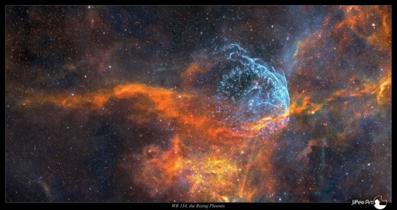 A vibrant image of the WR 124 nebula, known as the Roaring Phoenix, featuring swirling clouds of colorful gas and dust in blues, oranges, and yellows amidst a starry background.