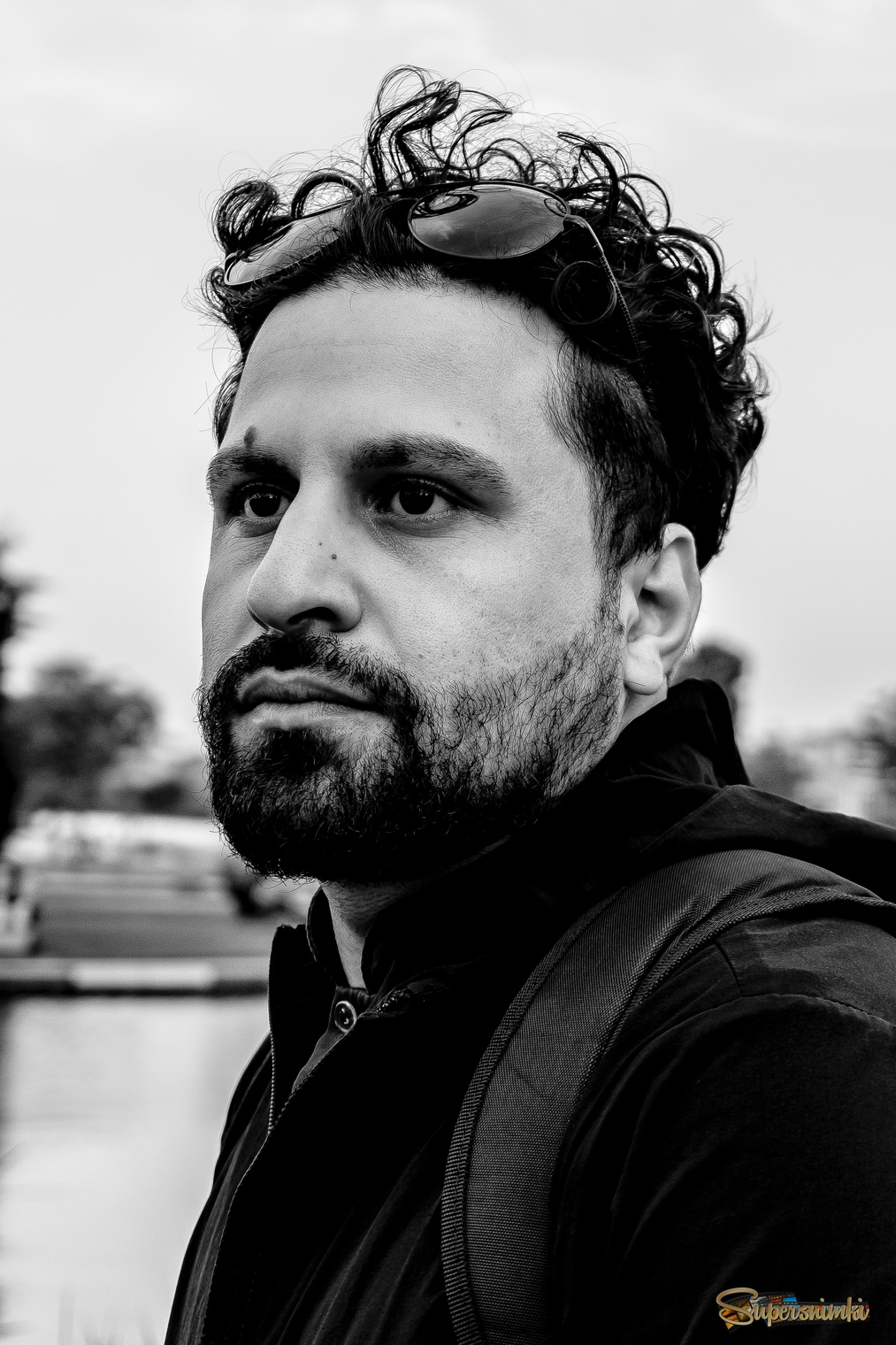 A striking, high-contrast black-and-white portrait of a man